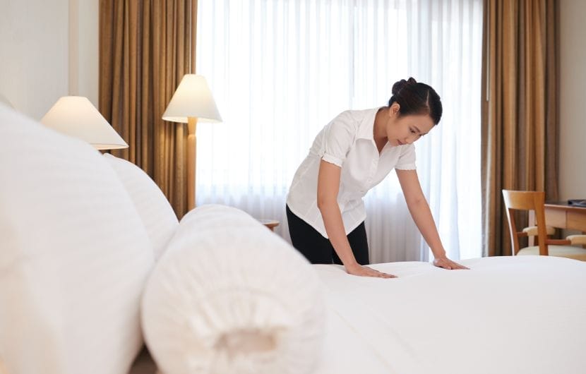 hotel guest room bedding tidying up