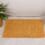 An Orange Chenille Bath Mat