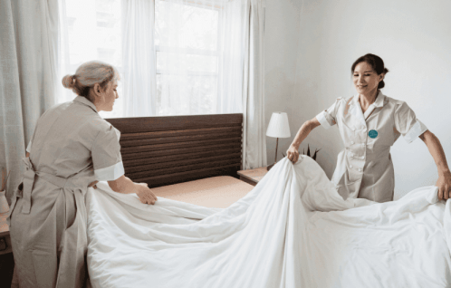 sorting hotel room bed sheets